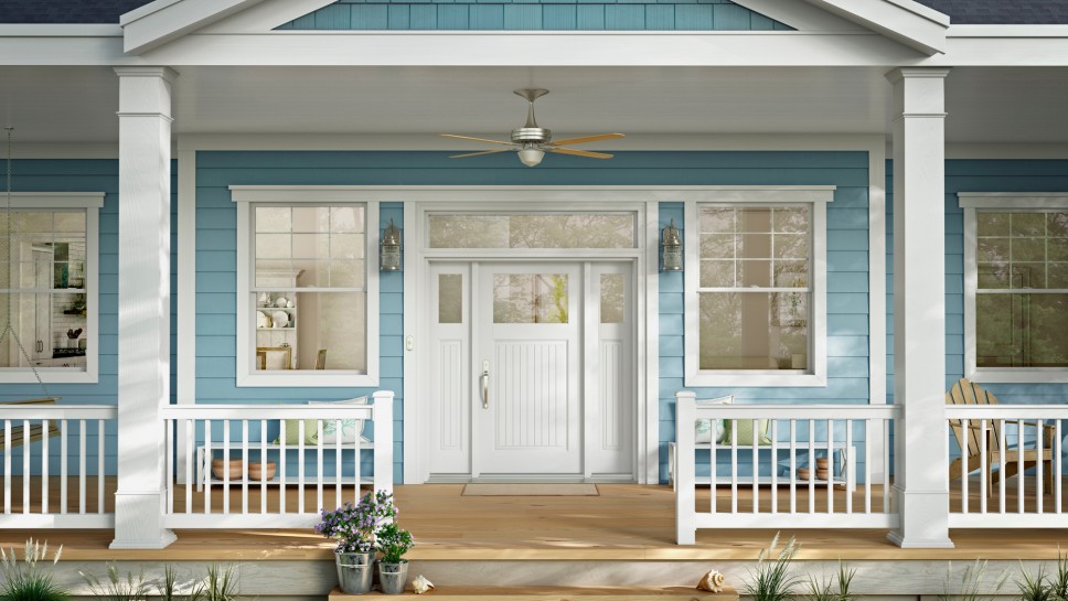 Large front porch extending along the entire front of a blue siding home with large white windows
